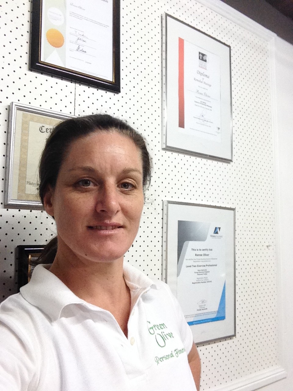 Renée Oliver standing in front of her professional qualifications